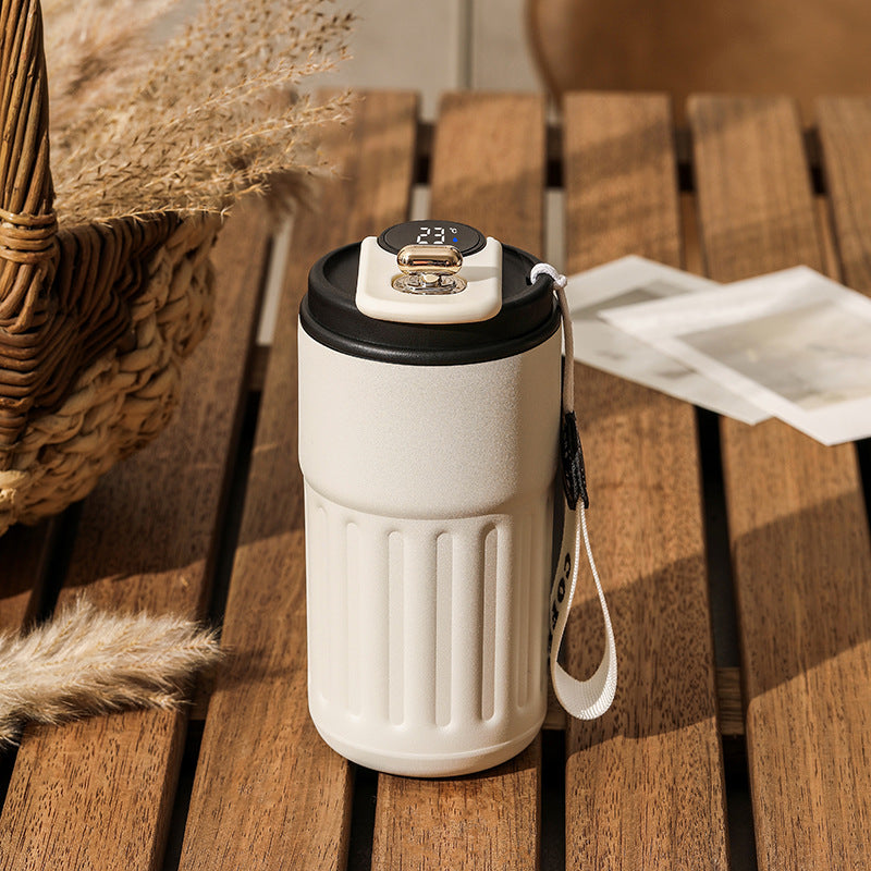 White vacuum insulated coffee mug thermos with digital lid and black rim, with carry strap