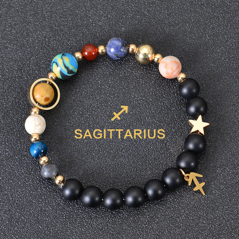 Sagittarius zodiac beaded bracelet with black lava stones and star charm, gold accents