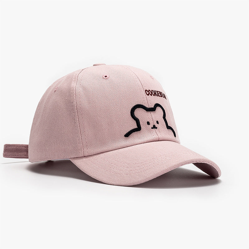 Light pink baseball cap with bear outline patch and curved brim