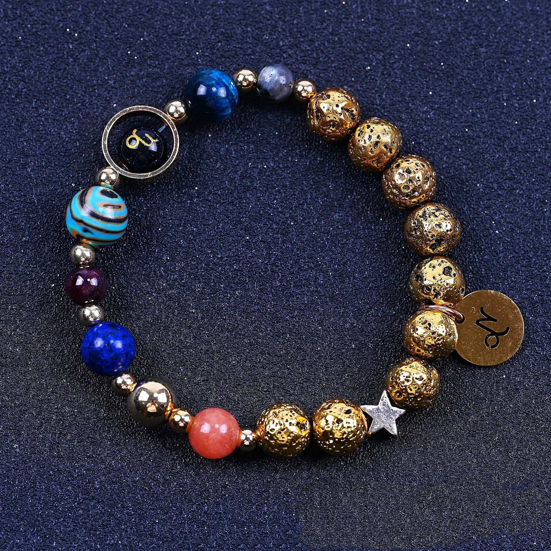 Beaded bracelet with blue, red, and gold beads; round zodiac charm and star detail.