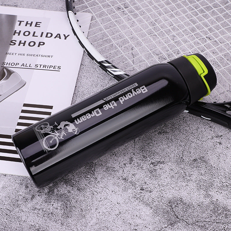 Bike water bottle in black with lime green trim and flip cap