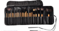 Makeup brush set in black roll pouch with zip closure and hanging strap