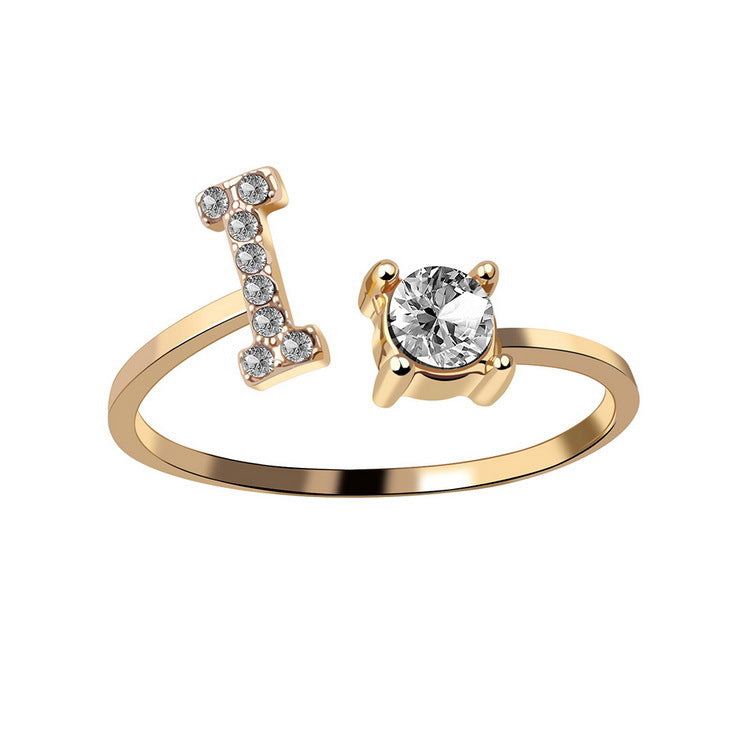 Adjustable initial letter ring with round crystal center and pavé letter detail, gold tone