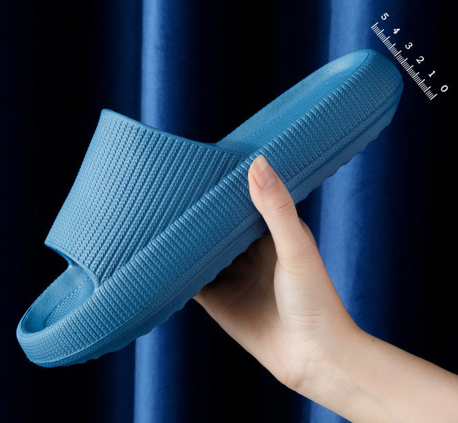 Blue knit slip-on slippers with open toe and cushioned sole.