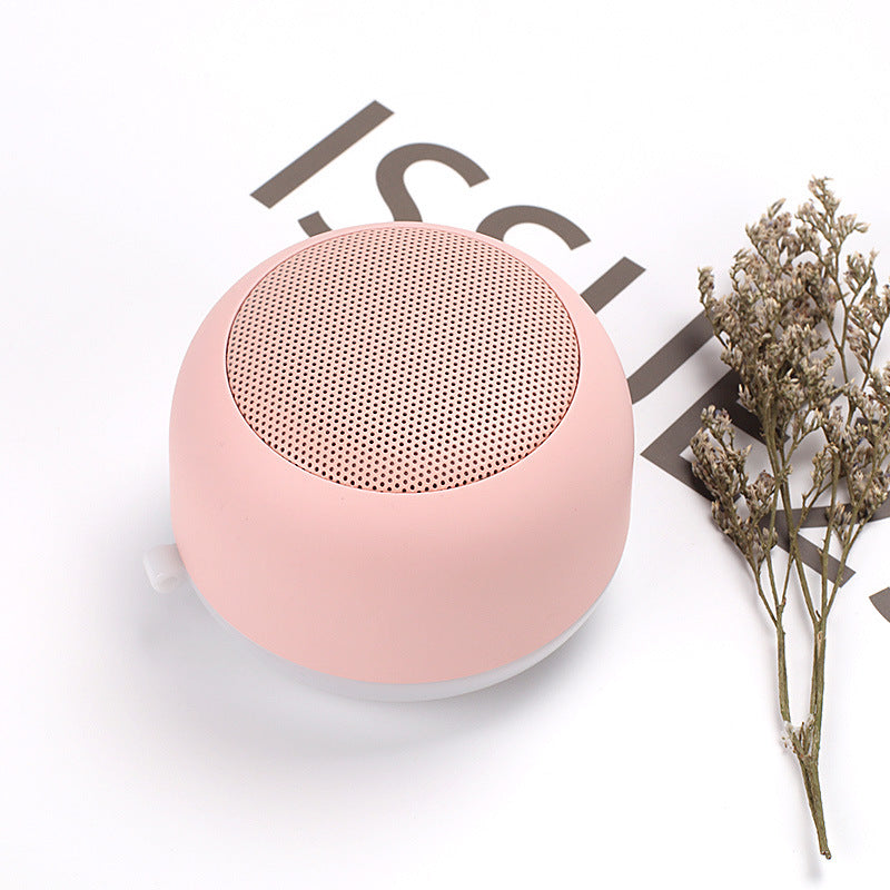 Wireless Bluetooth mini speaker, pink with textured grille top and rounded body