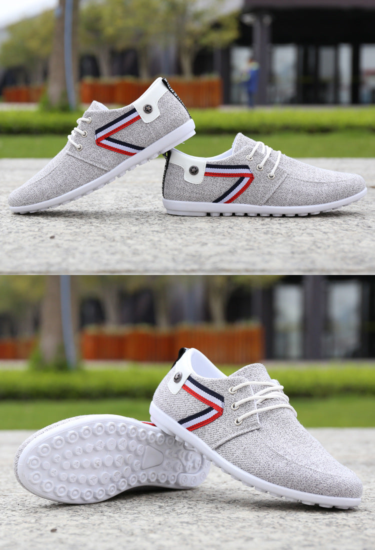 Light grey canvas lace-up sneakers with tricolor side stripe and white rubber sole