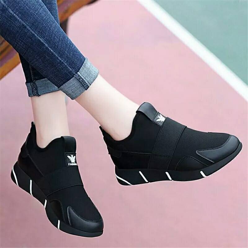 Black slip-on sports shoes with elastic side panel and white logo detail