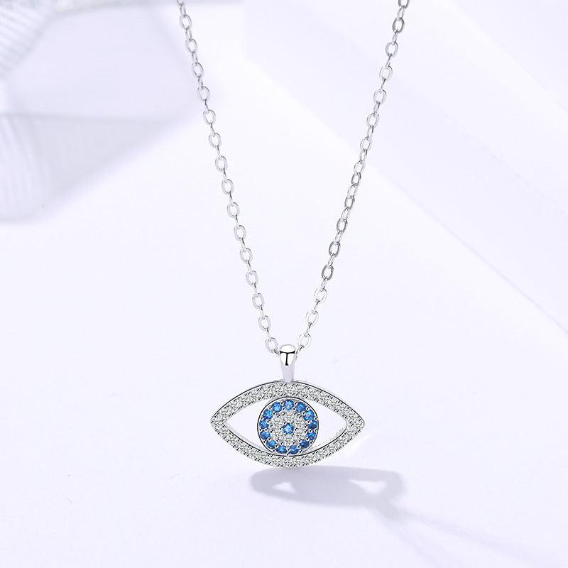 Sterling silver evil eye pendant necklace with blue center and glittery frame, chain links