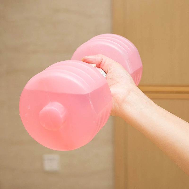 Pink water dumbbells held by hand with rounded barrel weights