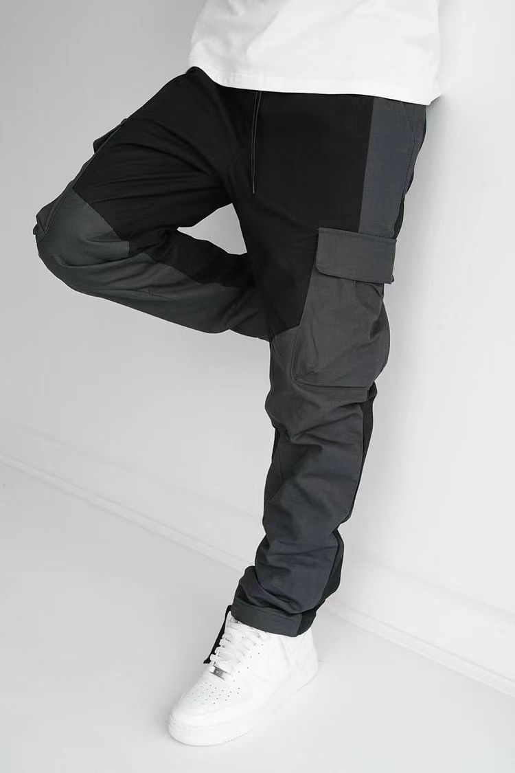 Black cargo trousers with knee patch pocket, relaxed fit, taper to cuff