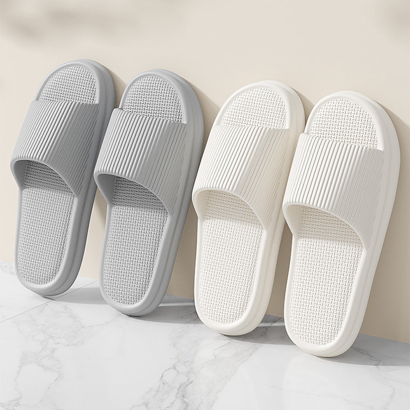 Set of grey and white slip-on home slippers with textured footbeds