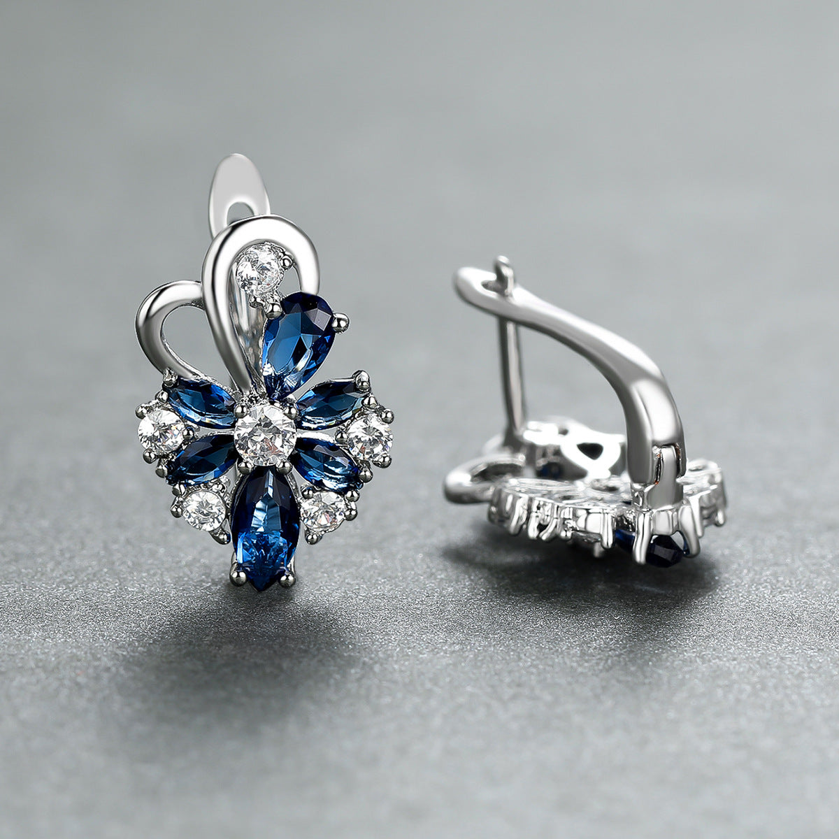 Flower drop-shaped zircon earrings with blue and clear stones in silver-tone settings