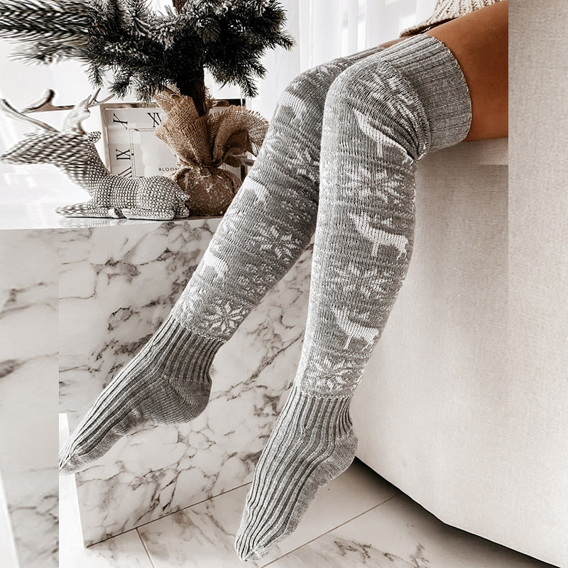 Pair of gray over-the-knee knitted socks with reindeer and snowflake jacquard