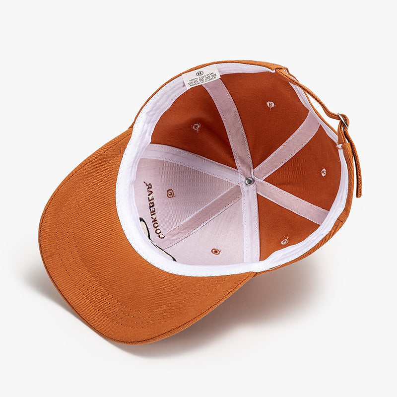 Orange baseball cap showing interior mesh and adjustable strap
