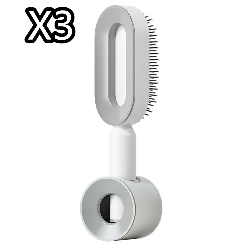 Self-cleaning hair brush pair with white handles and light gray oval brush heads