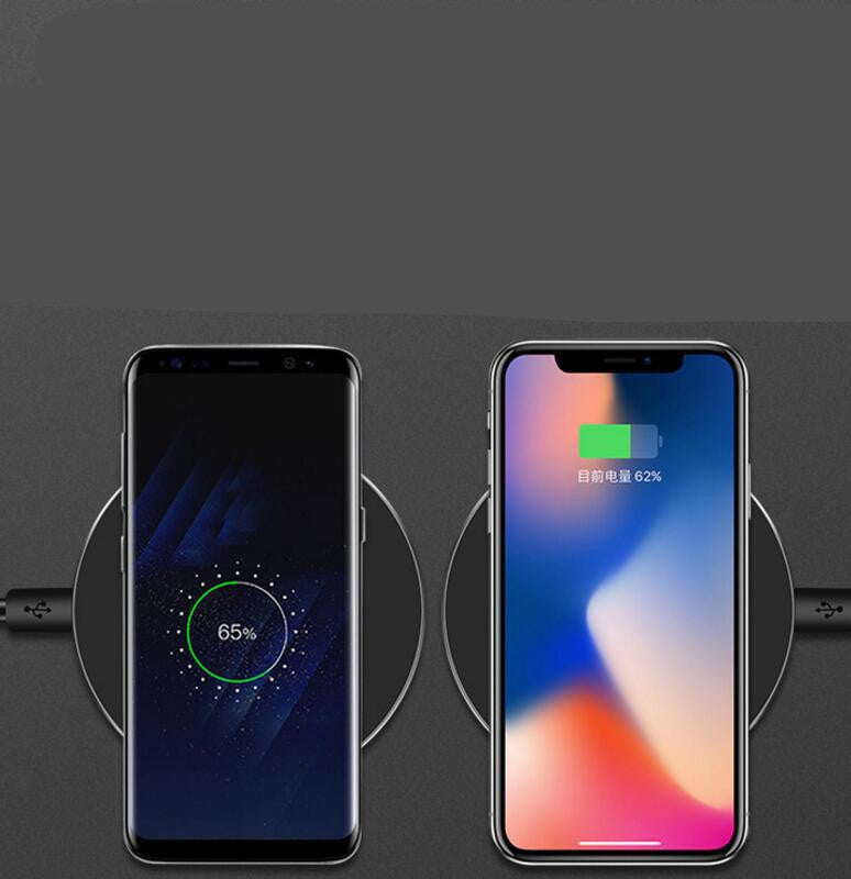 Black wireless charger pad holding two phones during wireless charging