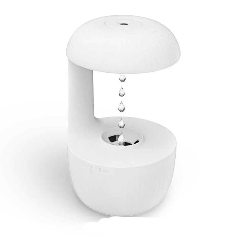 White cool mist humidifier with water droplet stream and circular top outlet.
