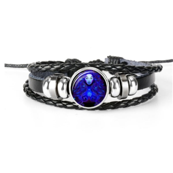 Braided leather-look bracelet with glowing round zodiac charm, surrounded by a silver bezel.