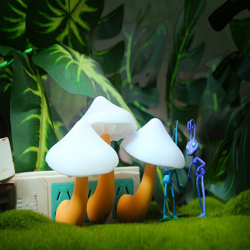 White plug-in mushroom LED night lights on wall outlet strip with glowing caps