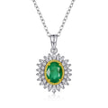 Silver pendant necklace with oval green gemstone center, gold bezel, crystal halo, full view