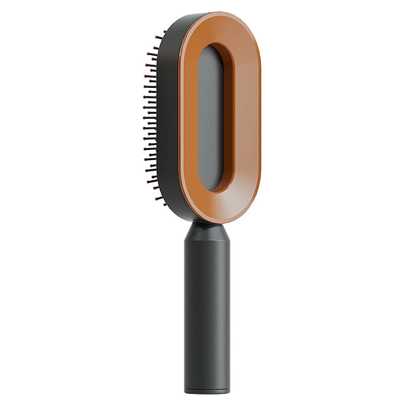 Self-cleaning hair brush with orange oval head and black pin bristles on dark handle