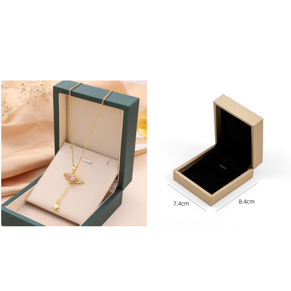 Gold angel-wing charm necklace in green gift box; beige box open view