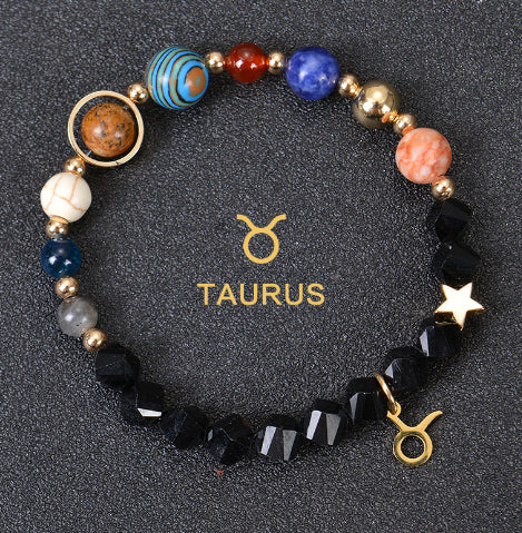 Zodiac bracelet with black lava beads and Taurus charm, star accent and gold charm.