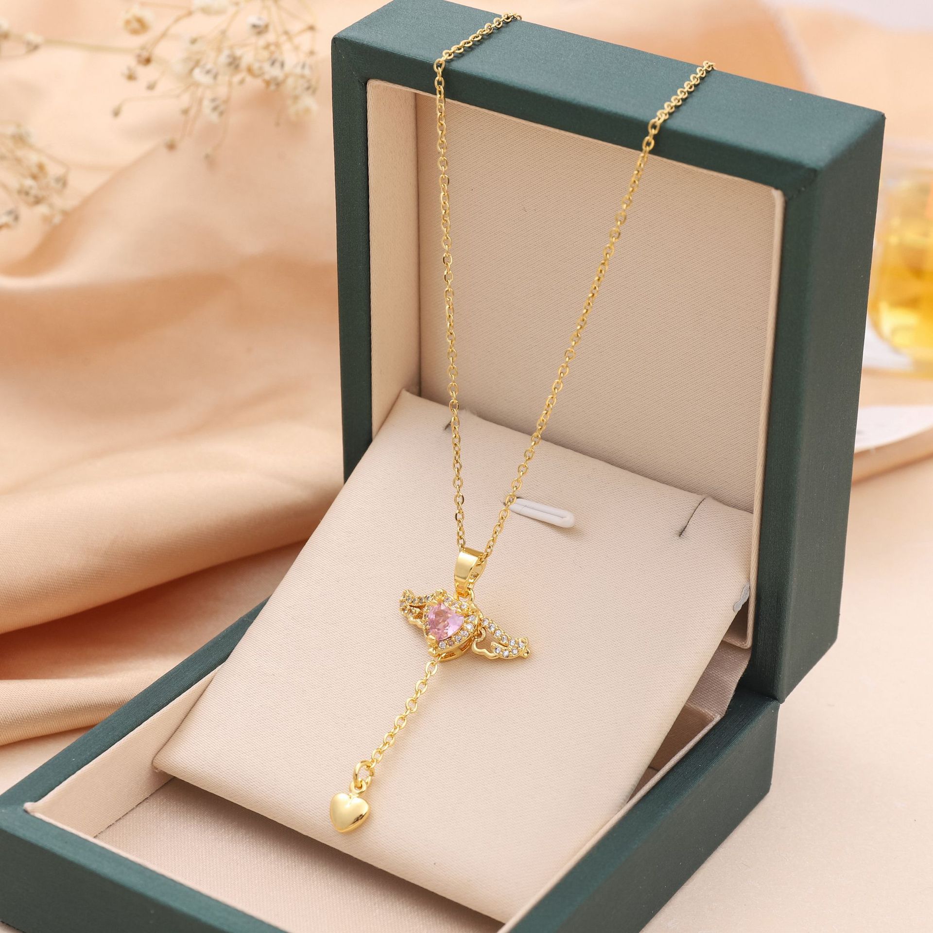 Gold angel-wing charm necklace with crystal heart pendant, in green gift box
