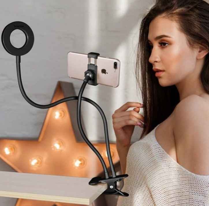 LED selfie ring light with phone clamp on tripod stand, illuminating ring