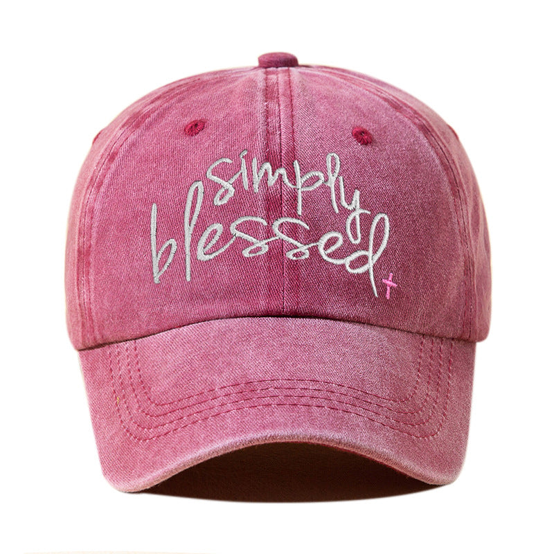 Wine red washed baseball cap with embroidered "Simply Blessed" script and pink cross