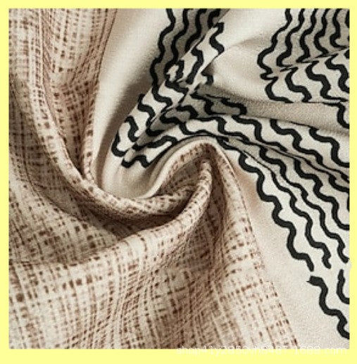 Close-up of slub linen fabric with wavy black vertical stripes and off-white base