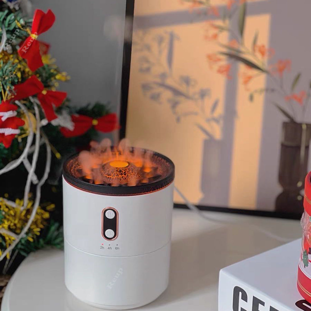 Aroma diffuser humidifier, white cylinder with orange flame-lit top near festive decor
