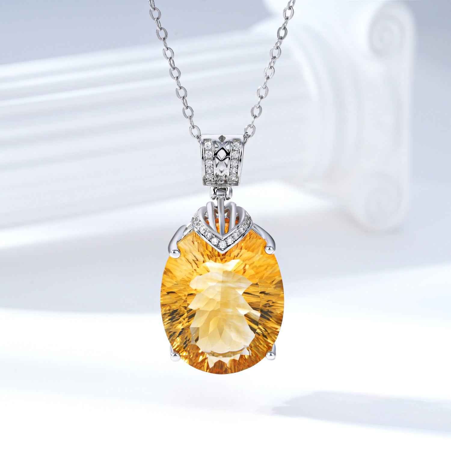 Silver necklace with oval yellow gemstone pendant and small crystal accents