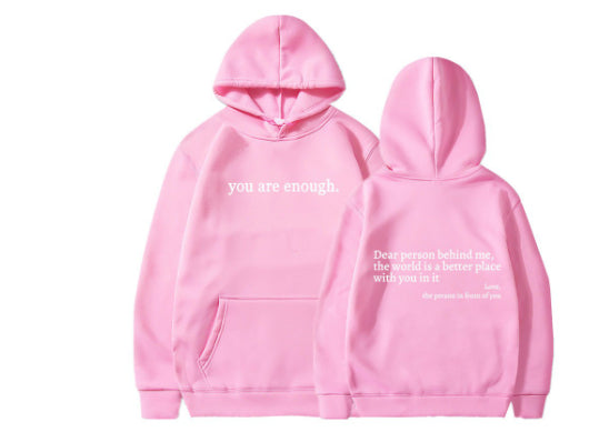 Pink plush hoodie with kangaroo pocket, drawstring hood, and front letter print