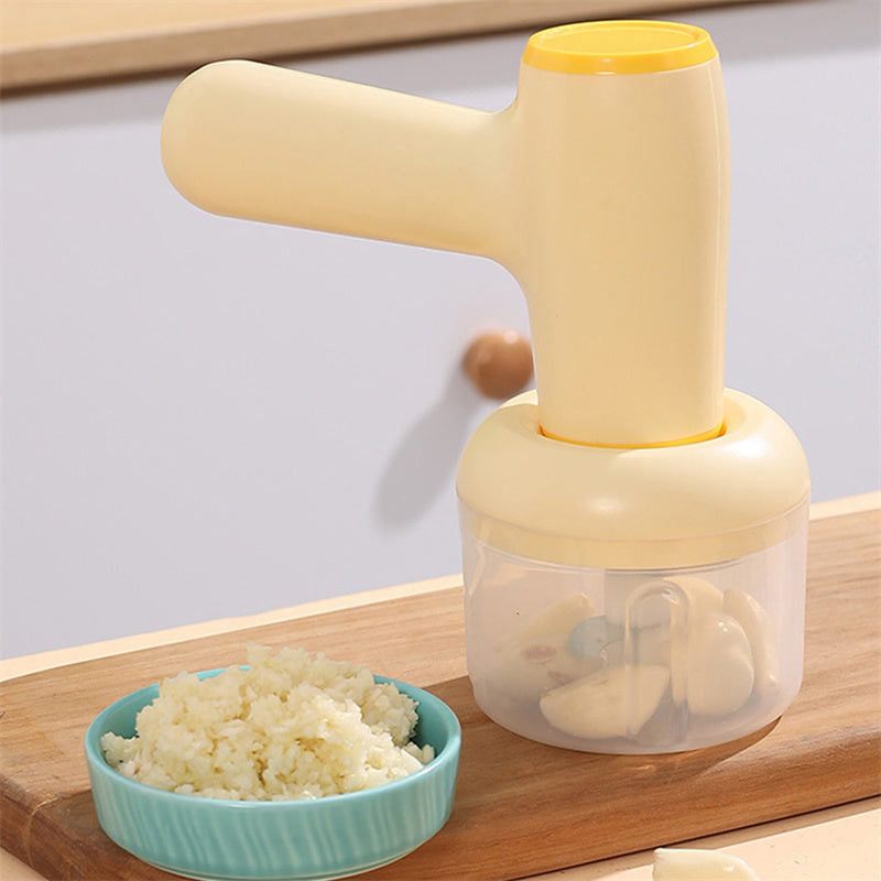 Beige electric chopper close-up with clear blending cup on wooden board