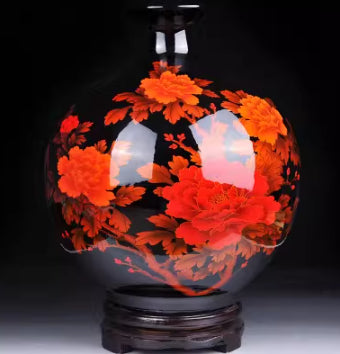 Dark ceramic vase with vivid orange floral artwork and glossy base.