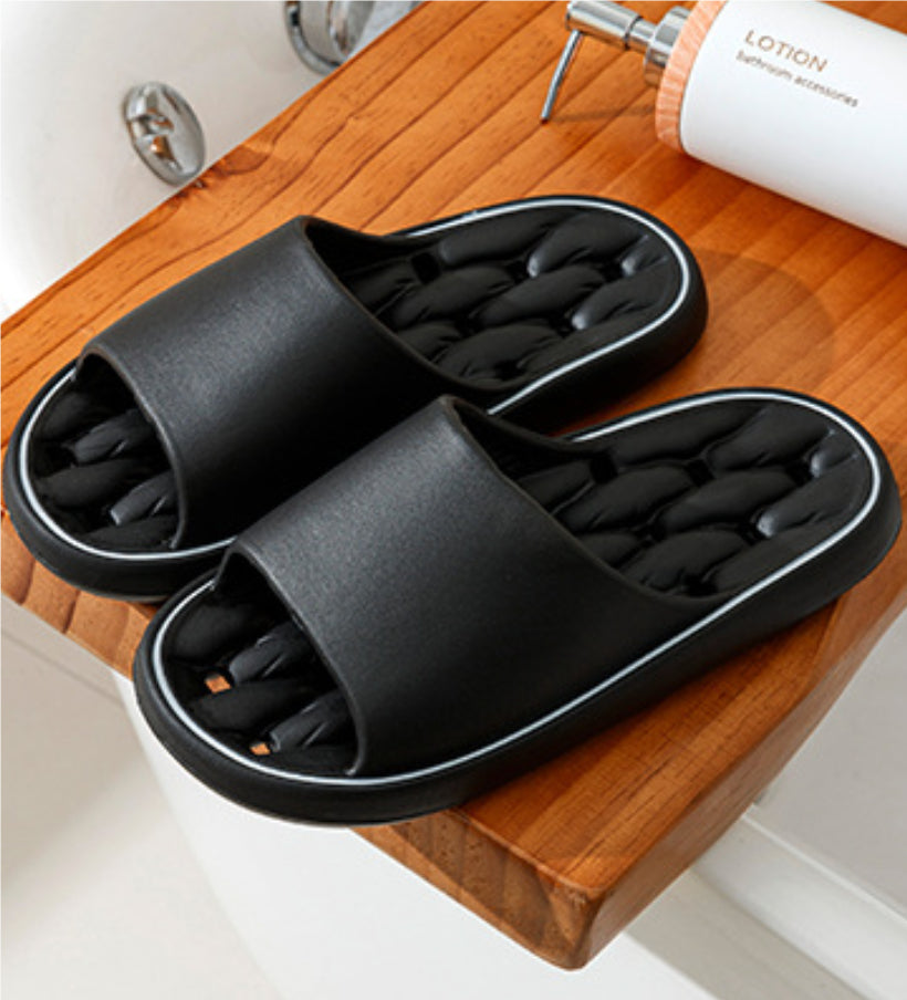Dark gray open-toe slide slippers with thick sole and molded cushioned footbed.