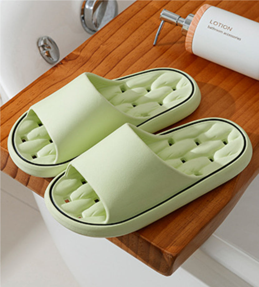 Light green open-toe slide slippers with thick sole and molded cushioned footbed.