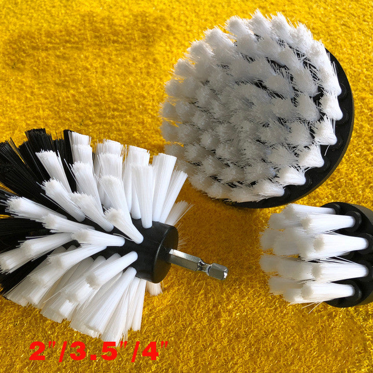 Drill brush head with white and black bristles on yellow base and metal shaft