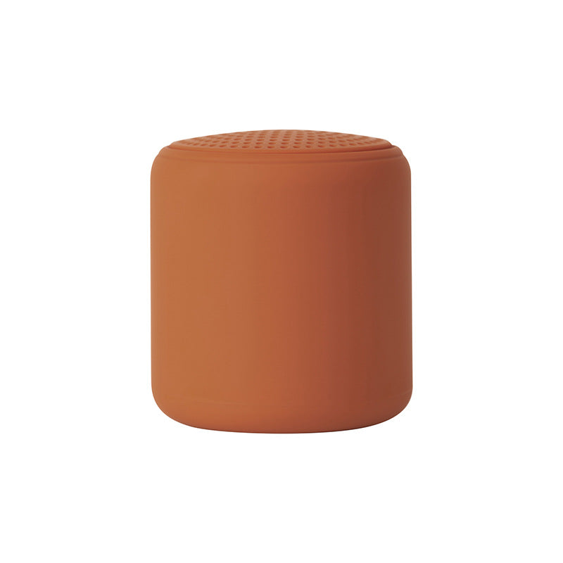 Portable wireless mini speaker, orange cylinder with perforated top grille