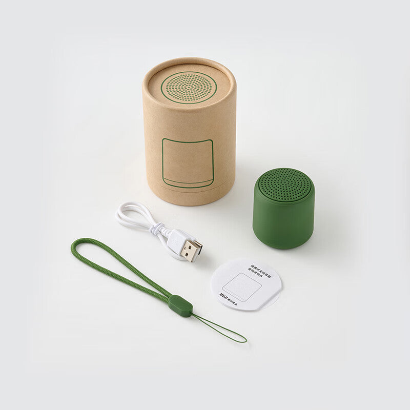 Portable wireless mini speaker, green cylindrical body with perforated top grille